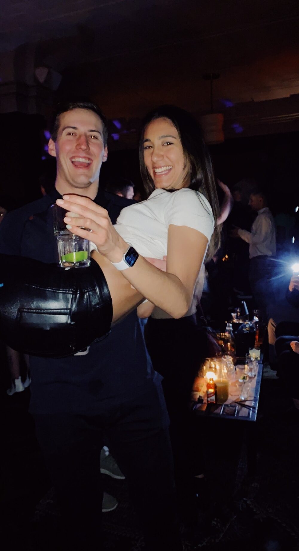 Ryan carrying a laughing Maddie at a party